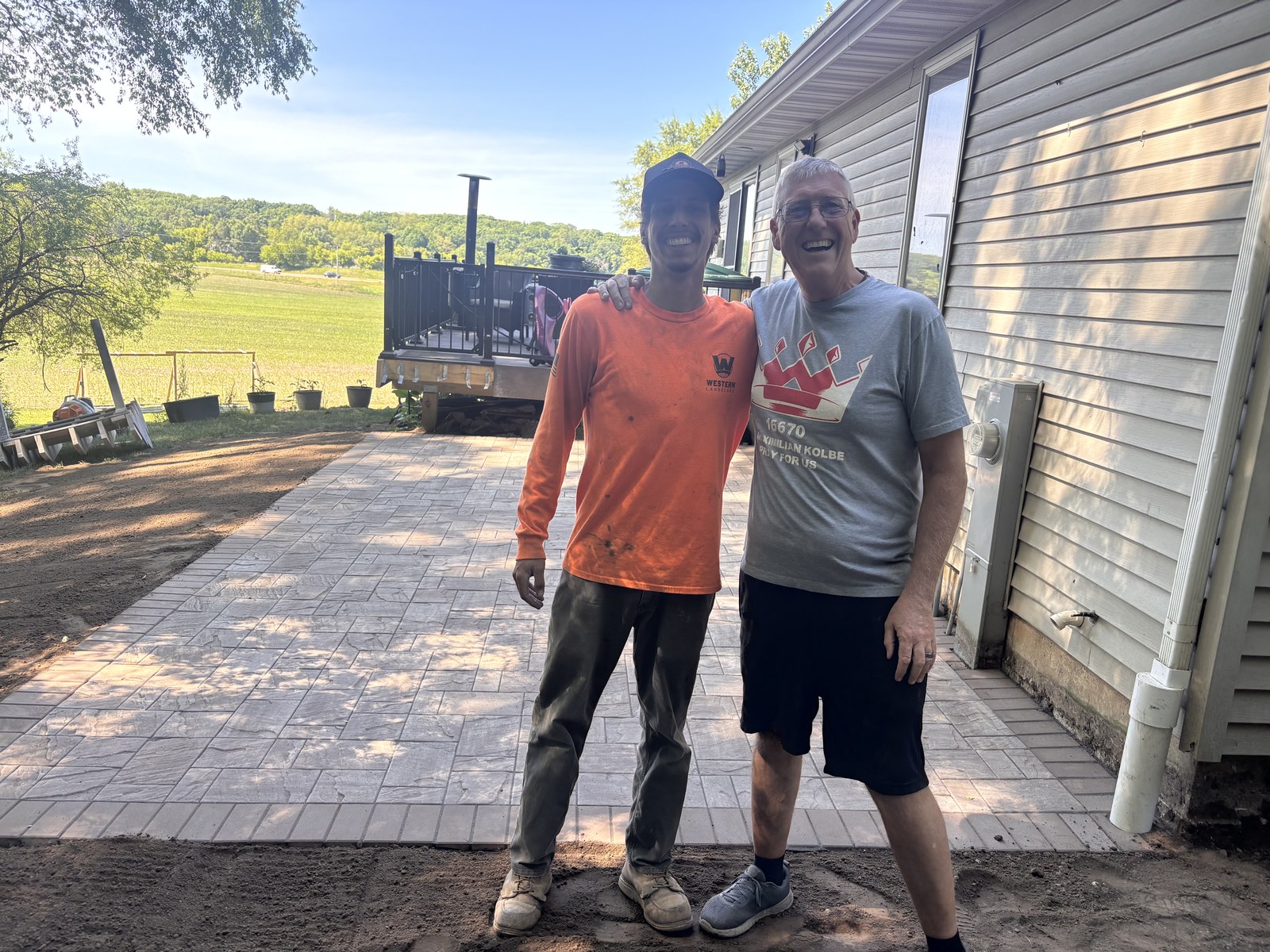 Western Landscape crew with a homeowner on a finished paver patio